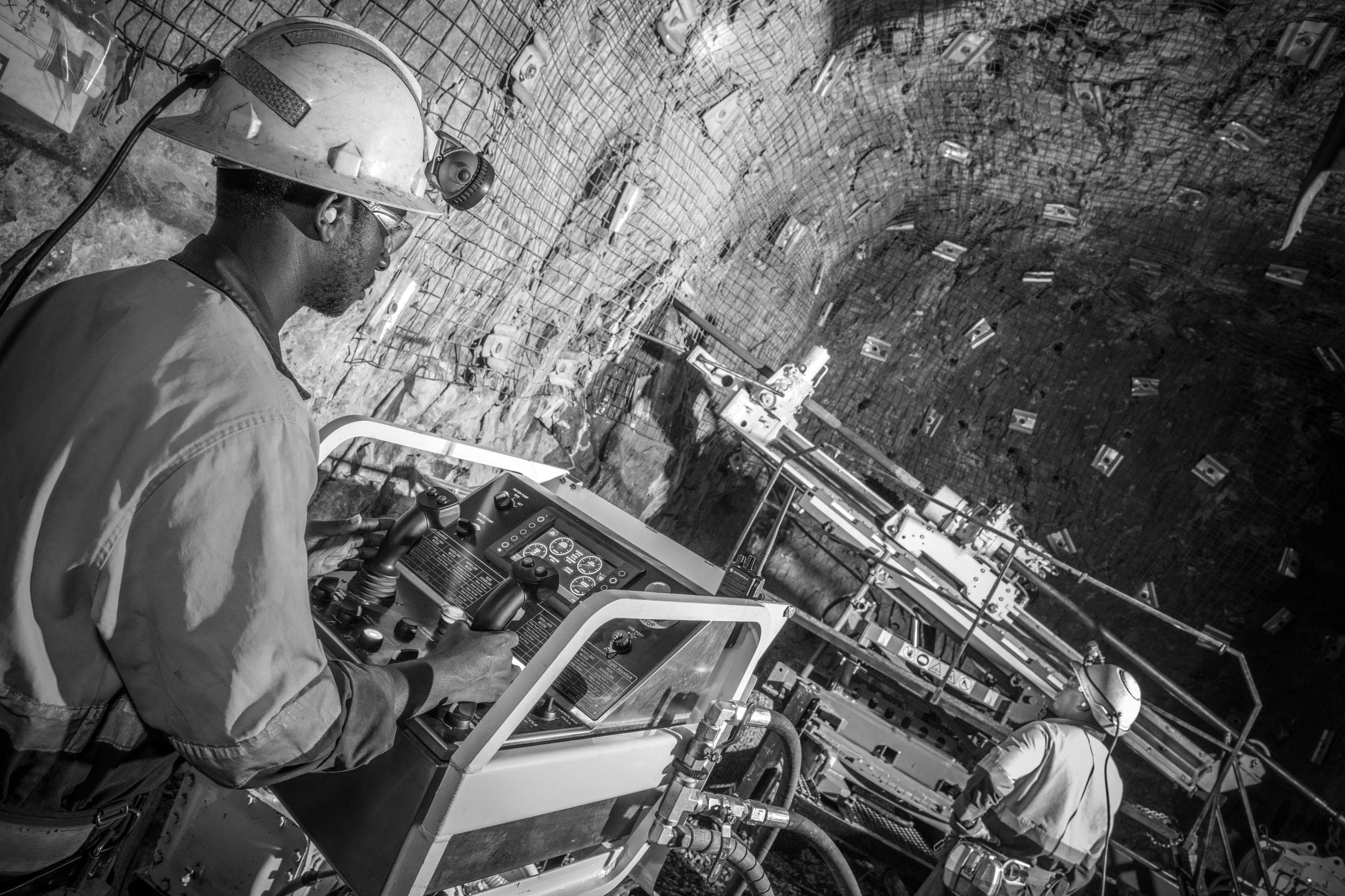 Operator at the controls of an underground drill rig